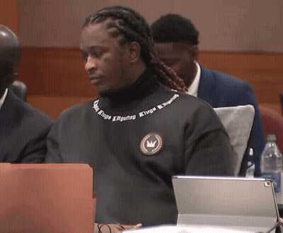 A Man Wearing A Black Sweater That Says Kings Signing Kings Signing GIF