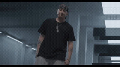 A Man Wearing A Black T-Shirt And A Bandana Has The Letter B On His Arm GIF