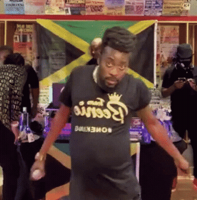 A Man Wearing A Black T-Shirt That Says Reese 'S Peanut Butter GIF