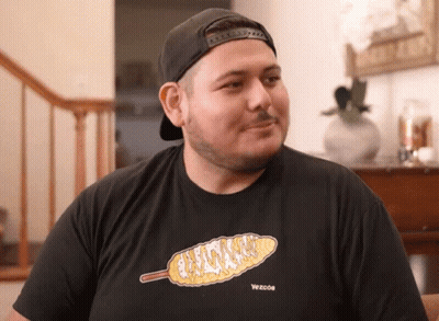 A Man Wearing A Black T-Shirt With A Picture Of Corn On The Cob On It GIF