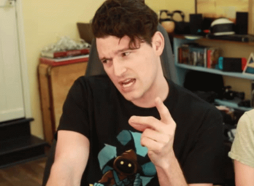 A Man Wearing A Black T-Shirt With A Picture Of Jabba The Hutt On It Points At Something GIF
