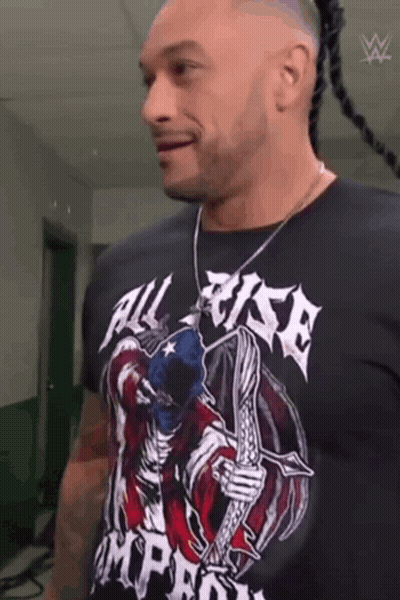 A Man Wearing A Black T-Shirt With A Skeleton On It . GIF