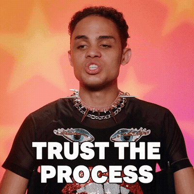 A Man Wearing A Black T-Shirt With Spikes Around His Neck Says " Trust The Process " GIF