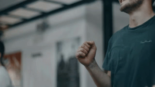 A Man Wearing A Black T-Shirt With The Word Pierre Cardin Written On It GIF