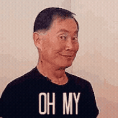 A Man Wearing A Black T-Shirt With The Words `` Oh My '' On It Is Making A Funny Face . GIF