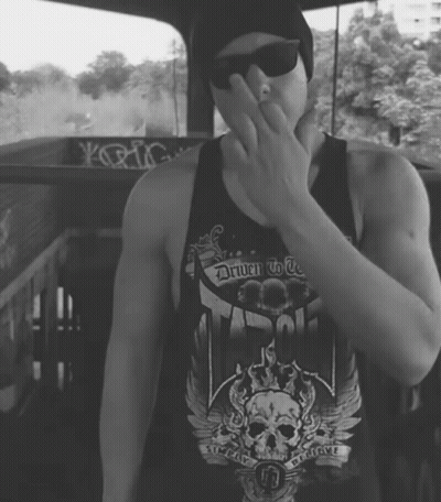 A Man Wearing A Black Tank Top That Says Driven To Be GIF