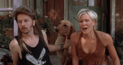 A Man Wearing A Black Tank Top With An Eagle On It Is Standing Next To A Woman And A Dog GIF