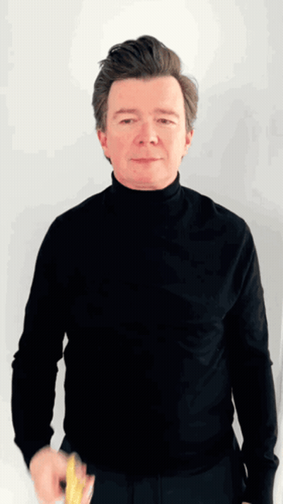 A Man Wearing A Black Turtleneck Is Holding A Yellow Object GIF
