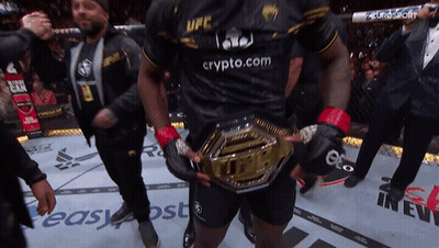 A Man Wearing A Black Ufc Shirt Holds A Gold Belt GIF