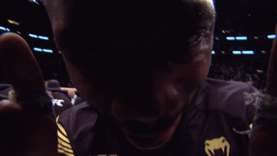 A Man Wearing A Black Ufc Shirt With Crypto.com On It GIF