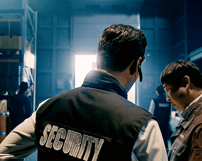 A Man Wearing A Black Vest That Says Security On It GIF