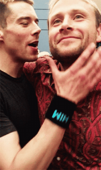 A Man Wearing A Black Wristband That Says Win On It GIF