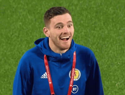 A Man Wearing A Blue Adidas Jacket Is Smiling On A Field GIF