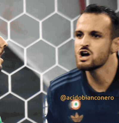 A Man Wearing A Blue Adidas Jersey Is Talking To Another Man GIF