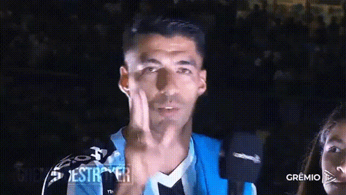 A Man Wearing A Blue And Black Jersey Is Giving The Middle Finger GIF