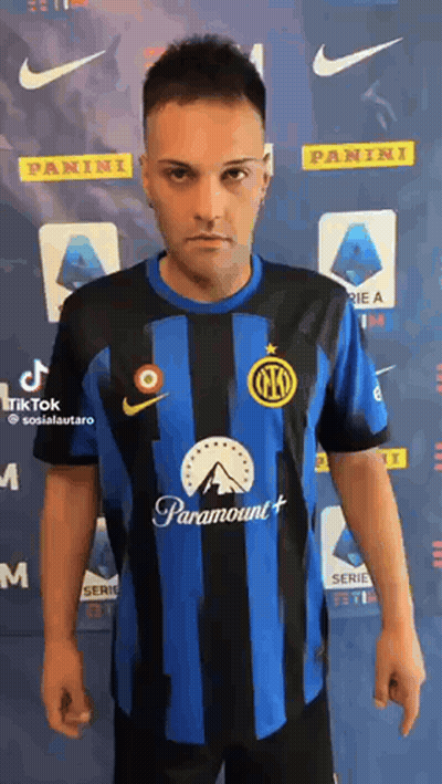 A Man Wearing A Blue And Black Striped Soccer Jersey With Paramount On It . GIF