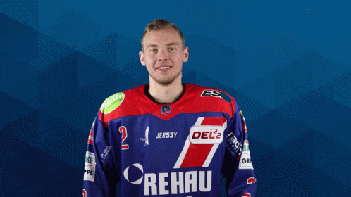 A Man Wearing A Blue And Red Rehau Jersey Poses For A Picture GIF