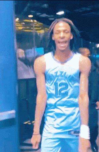A Man Wearing A Blue And White Jersey With The Number 12 On It GIF