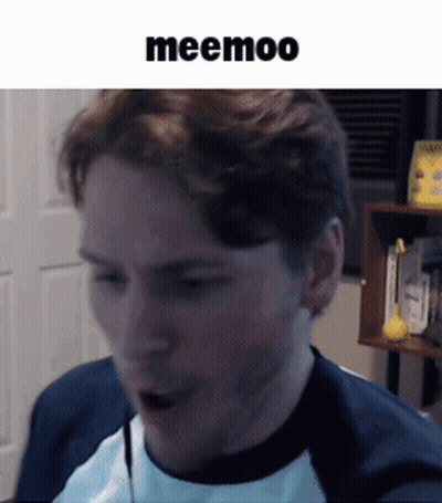 A Man Wearing A Blue And White Shirt Is Talking Into A Microphone With The Word Meemoo Above Him GIF
