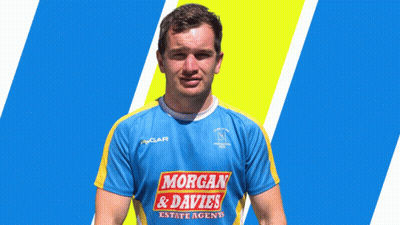 A Man Wearing A Blue And Yellow Shirt With Morgan & Davies On It GIF