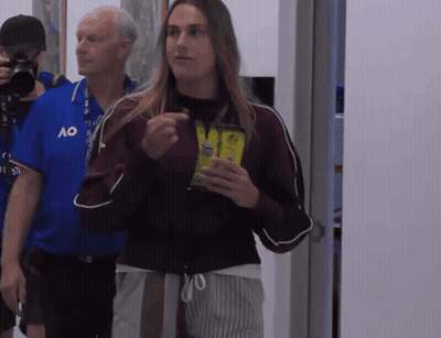 A Man Wearing A Blue Ao Shirt Stands Next To A Woman GIF