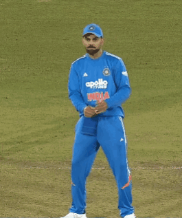 A Man Wearing A Blue Apollo Shirt Stands On A Field GIF