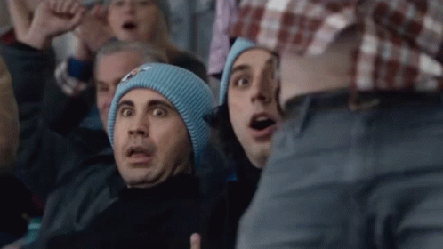 A Man Wearing A Blue Beanie Is Making A Surprised Face GIF