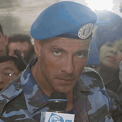 A Man Wearing A Blue Beret Is Holding A Microphone With A Box That Says Cnn On It GIF