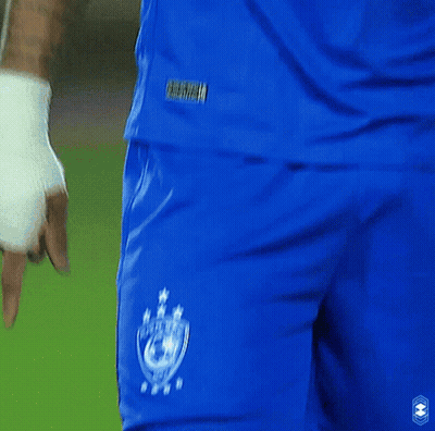A Man Wearing A Blue Emaar Jersey Looks To His Left GIF