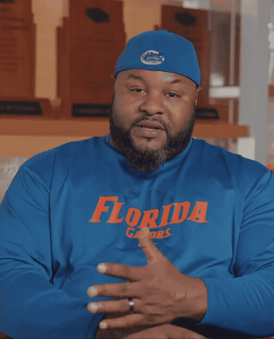 A Man Wearing A Blue Florida Gators Shirt Talks GIF