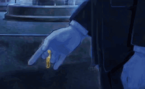 A Man Wearing A Blue Glove Is Holding A Gold Ring In His Hand GIF