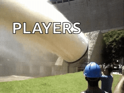 A Man Wearing A Blue Hard Hat Is Standing In Front Of A Large Pipe That Says Players On It . GIF
