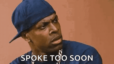 A Man Wearing A Blue Hat And A Necklace Is Talking To Someone And Says `` Spoke Too Soon '' . GIF