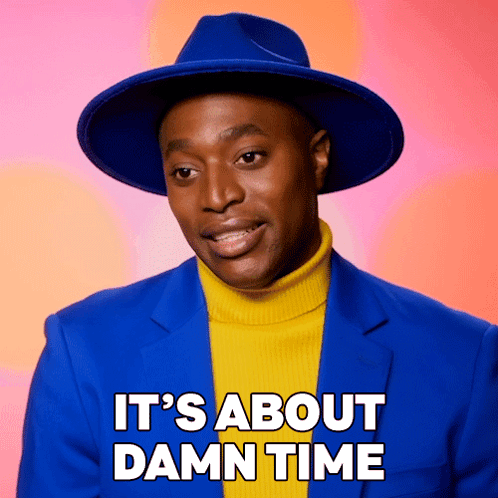 A Man Wearing A Blue Hat And A Yellow Turtleneck Sweater Says " It 'S About Damn Time " GIF