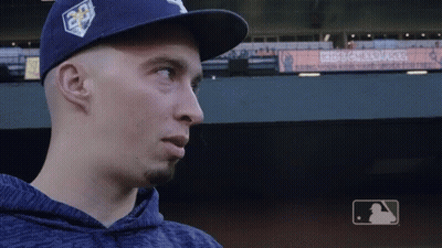 A Man Wearing A Blue Hat Stands In Front Of A Sign For Kids Challenge GIF