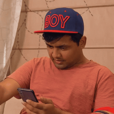 A Man Wearing A Blue Hat That Says Boy On It GIF