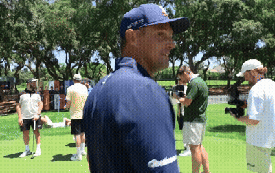 A Man Wearing A Blue Hat That Says New York Is Standing On A Golf Course GIF