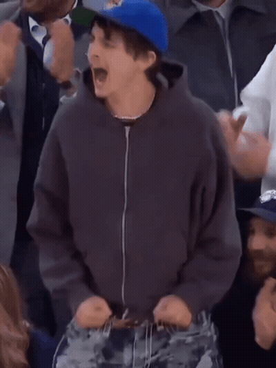 A Man Wearing A Blue Hat That Says Oklahoma On It GIF