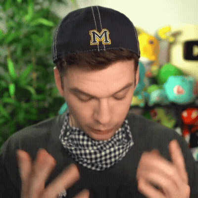 A Man Wearing A Blue Hat With A Letter M On It GIF