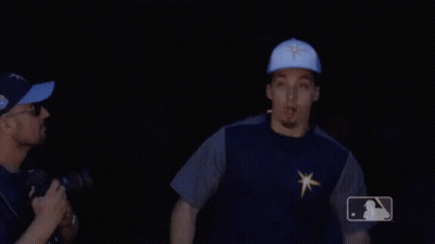 A Man Wearing A Blue Hat With A Star On It Is Pointing GIF