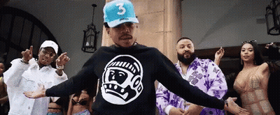 A Man Wearing A Blue Hat With The Number 3 On It Is Dancing With A Group Of People GIF
