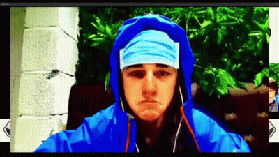 A Man Wearing A Blue Hooded Jacket And A Bandana On His Head GIF
