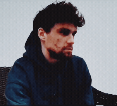 A Man Wearing A Blue Hoodie With The Words " You Need A Warm Glass Of Shut The Hell Up " Below Him GIF