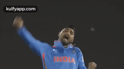 A Man Wearing A Blue India Jersey Is Raising His Arms In The Air GIF