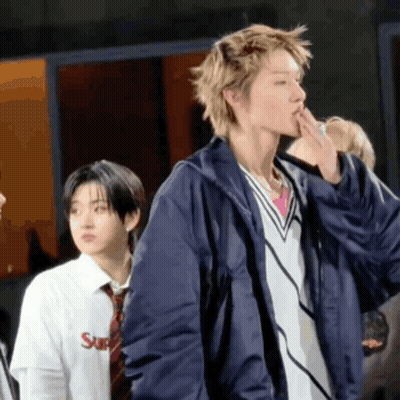 A Man Wearing A Blue Jacket And A White Shirt With The Word Supreme On It GIF