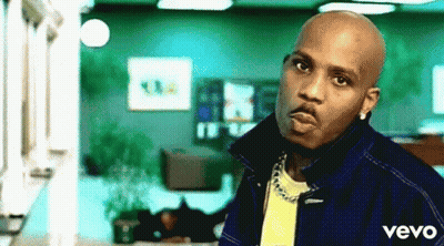 A Man Wearing A Blue Jacket And A Yellow Shirt With The Word Vevo On The Bottom GIF