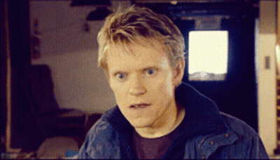 A Man Wearing A Blue Jacket Looks At The Camera GIF