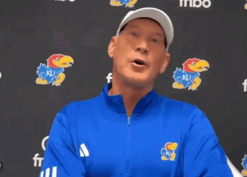 A Man Wearing A Blue Jacket With A Ku Logo On The Front GIF