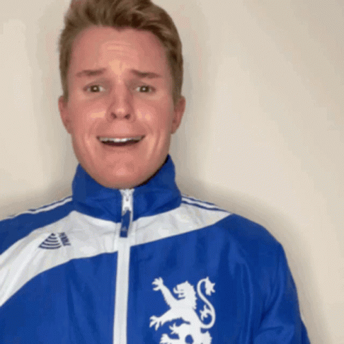 A Man Wearing A Blue Jacket With A Lion On It GIF