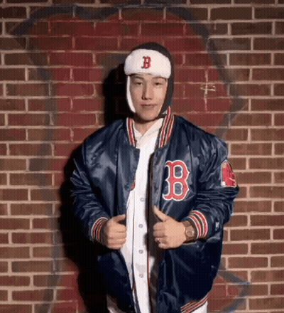A Man Wearing A Blue Jacket With The Letter B On The Front GIF